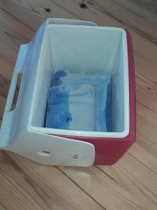 a red and white cooler sitting on a wooden floor at La Reine in St-Etienne de Bolton