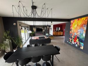 a dining room with a black table and chairs at Villa à Lux in Lux
