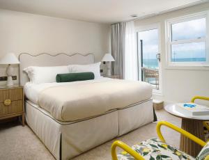 a bedroom with a large bed and a balcony at THE NICI Newquay in Newquay +48 photos