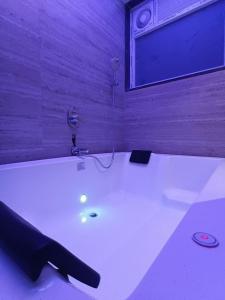 a large white bath tub in a room at hotel sunfire in Chhindwāra +2 photos