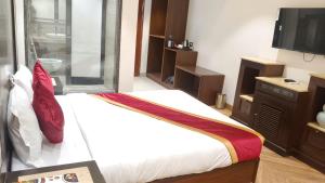 a bedroom with a bed and a television in it at hotel sunfire in Chhindwāra