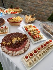 a table with many different types of food on it at Vikend house Cvrcak in Slankamenački Vinogradi