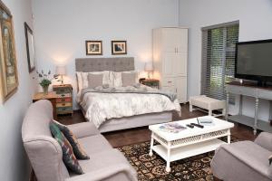a living room with a bed and a tv at Annies House in Cradock +53 photos