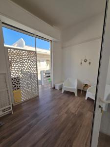 a living room with a large sliding glass door at AM-MARE in Villaggio Azzurro