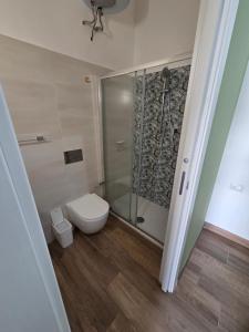 a bathroom with a toilet and a glass shower at AM-MARE in Villaggio Azzurro +24 photos