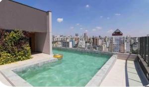a swimming pool on the roof of a building at U House in São Paulo