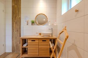 a bathroom with a sink and a mirror at L'évasion verte in Colroy-la-Roche +32 photos