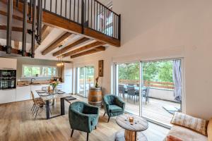 a living room with a couch and a table and chairs at L'évasion verte in Colroy-la-Roche
