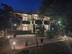 a building with a courtyard at night with lights at Estelle Hotel in Gerakini