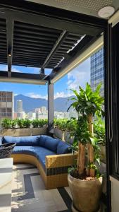 a balcony with a blue couch on top of a building at Hotel Astoria Ipanema in Rio de Janeiro