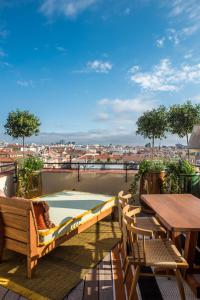 a balcony with a table and a swimming pool at Brach Madrid - Evok Collection in Madrid +53 photos