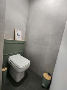 a bathroom with a white toilet in a room at Une escapade en Provence in Pertuis