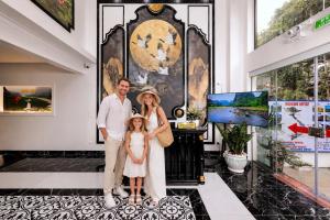 a man and a woman and a child standing in a museum at Tam Coc Center Friendly Hotel in Ninh Binh +27 photos