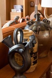 a group of vases sitting on a wooden table at Brach Madrid - Evok Collection in Madrid