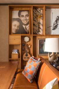 a room with a couch with a lamp and a guitar at Brach Madrid - Evok Collection in Madrid