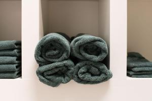 a pile of towels on a shelf in a bathroom at Hannes in Schagen