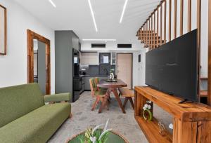 a living room with a large television and a table at September15 Boutique Suites - Nikiana in Nikiana