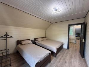 a bedroom with two beds and a ceiling at Cottage v Gorakh in Izki +53 photos