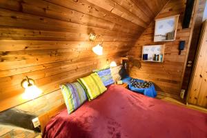 a bedroom with a large bed in a wooden wall at Kulturgutleben in Möllenbeck