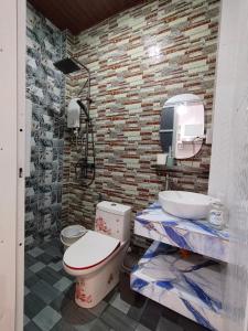 a bathroom with a toilet and a sink at Felrita Homestay in Alegria