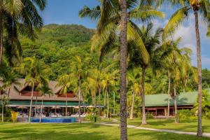 a resort with palm trees in front of it at Paradise Sun Hotel Seychelles in Baie Sainte Anne