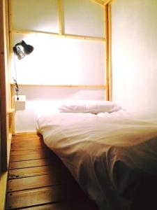 a bed in a room with a window at 33 Backpacker in Hengchun South Gate