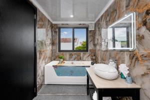 a bathroom with a tub and a sink at Tam Coc Center Friendly Hotel in Ninh Binh