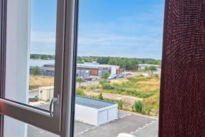 an open window with a view of a building at Studio for 2 in La Teste-de-Buch parking in La Teste-de-Buch