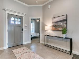 a room with a door and a table with a plant at Exquisite Escape in Moore! in Moore