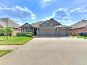a house with a driveway and a garage at Exquisite Escape in Moore! in Moore