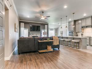 a living room with a couch and a kitchen at Exquisite Escape in Moore! in Moore +28 photos