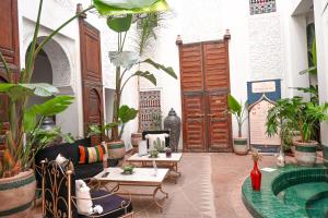 a living room filled with lots of plants at Riad N'S & Spa in Marrakesh