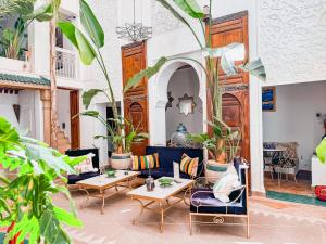 a living room with furniture and potted plants at Riad N'S & Spa in Marrakesh