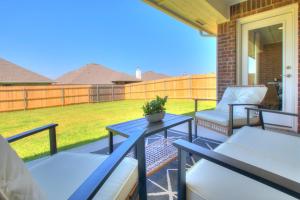 a patio with two chairs and a table on a porch at Oklahoma City's Hidden Gem in Moore