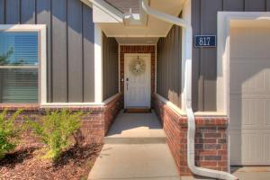 a house with a white door and a street sign at Oklahoma City's Hidden Gem in Moore