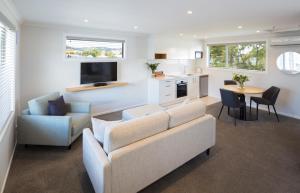 a living room with a couch and a table at Beechwood Boutique Accommodation in Dunedin