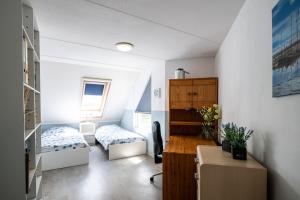 a small room with a bed and a desk in it at Penthouse Ostrea 60 in Nes