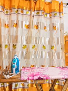 a table with a hair dryer and a curtain at Cozy & Secure 1BR Apartment in Central Luanda in Luanda