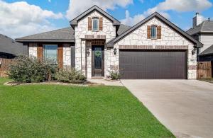 a brick house with a garage at Hazy Hollow Escape 4816 in Crowley