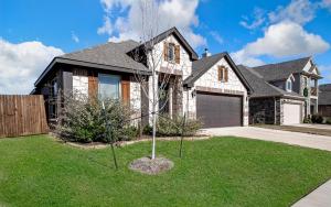a house with a tree in the front yard at Hazy Hollow Escape 4816 in Crowley