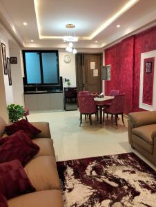a living room with a couch and a table at LMY Boutique Prestige Hotel Apartments - Murree Monal Expressway in Murree
