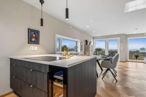 a kitchen with a island and a table with chairs at Apartment Lofoten, Leknes in Leknes