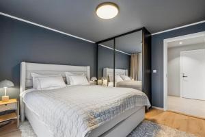 a bedroom with a large bed and a large mirror at Apartment Lofoten, Leknes in Leknes