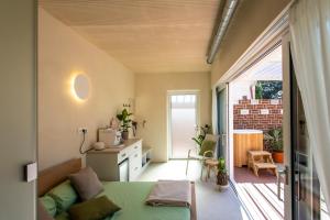 a small bedroom with a bed and a balcony at El Nido wellness a spa in Vysoké Mýto