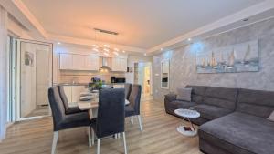 a living room and kitchen with a couch and a table at CASA di NATALIA, Spacious 2BR Apartment for 6 near Beach ,Free Parking in Kaštela