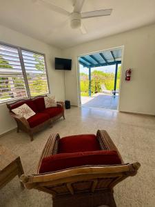 a living room with a couch and a tv at Villa del Carmen Boqueron in Cabo Rojo
