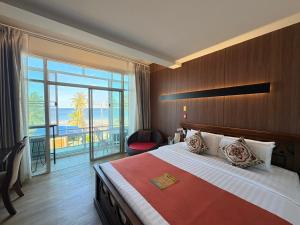 a hotel room with a bed and a large window at Talay Sai @ Thung Wua Laen in Chumphon +144 photos