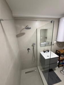 a bathroom with a shower and a sink at Harbour Light Residence in Bjeliši +7 photos