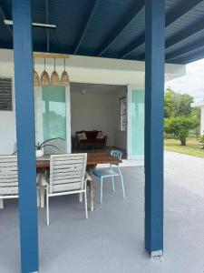 a patio with a wooden table and two chairs at Villa del Carmen Boqueron in Cabo Rojo
