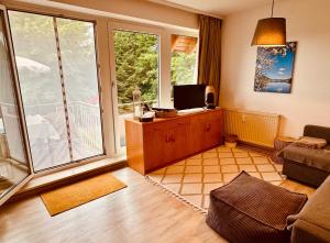 a living room with a large window and a couch at FeWo Fuchs Saig in Lenzkirch